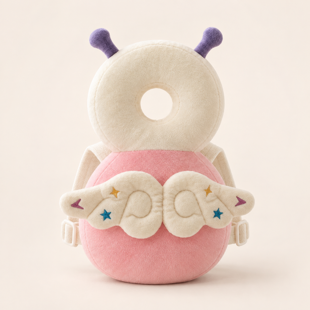 Elfin baby cushion backpack with pink body, ivory ring and embroidered wings on a cream background